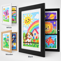 MyPicasso magnetic kids art frames in White, Natural Wood and Black, each displaying a different child's drawing